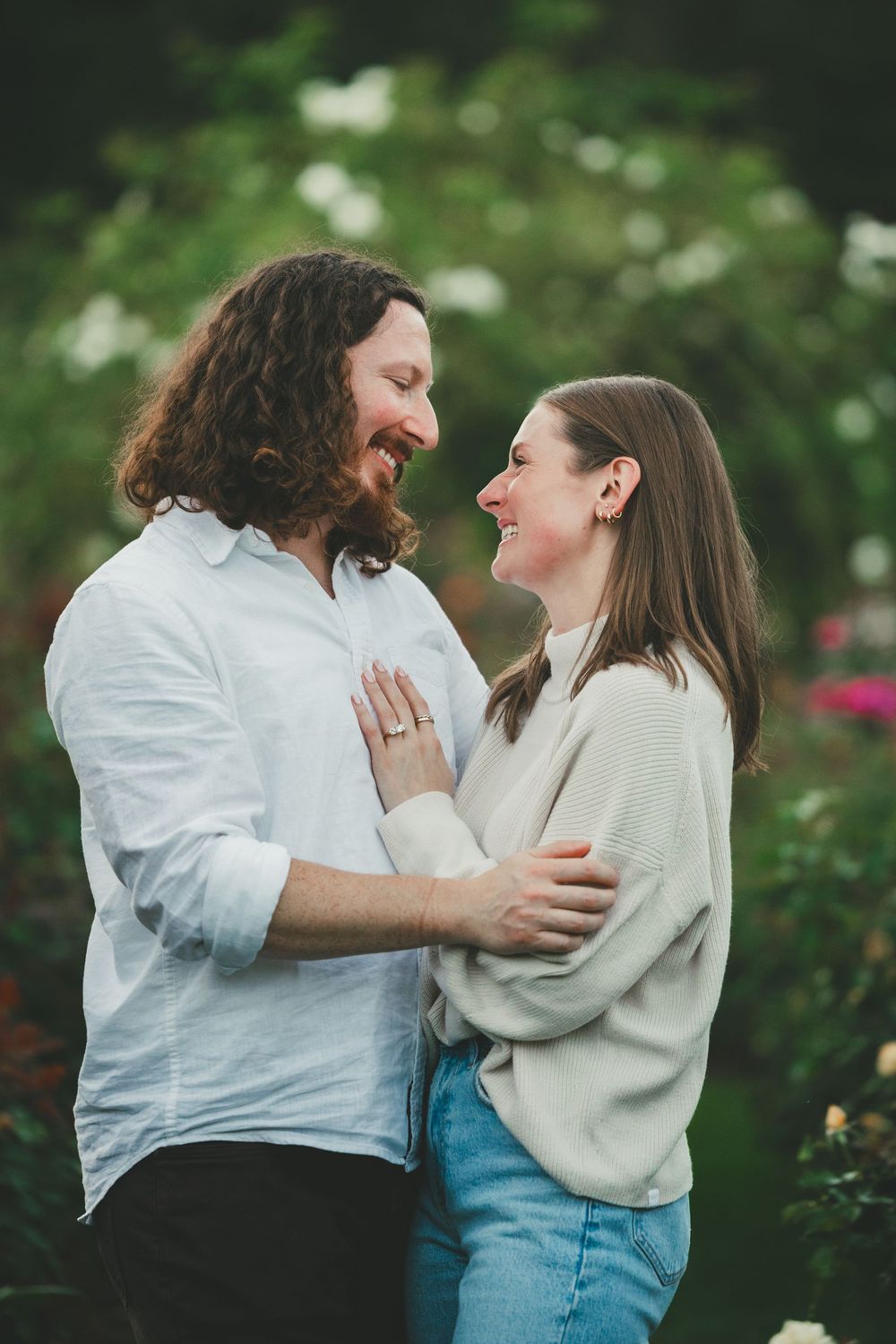 Couple walking through rose garden after Arlington VA proposal