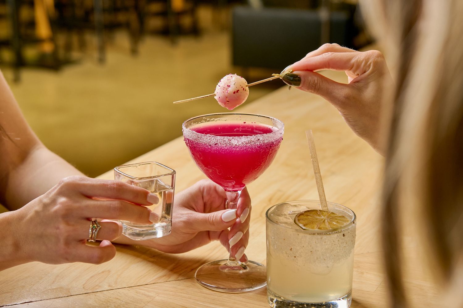 Two woman having cocktails in a fancy restaurante. City Food Hall Doral. Gustavo Lopez photography