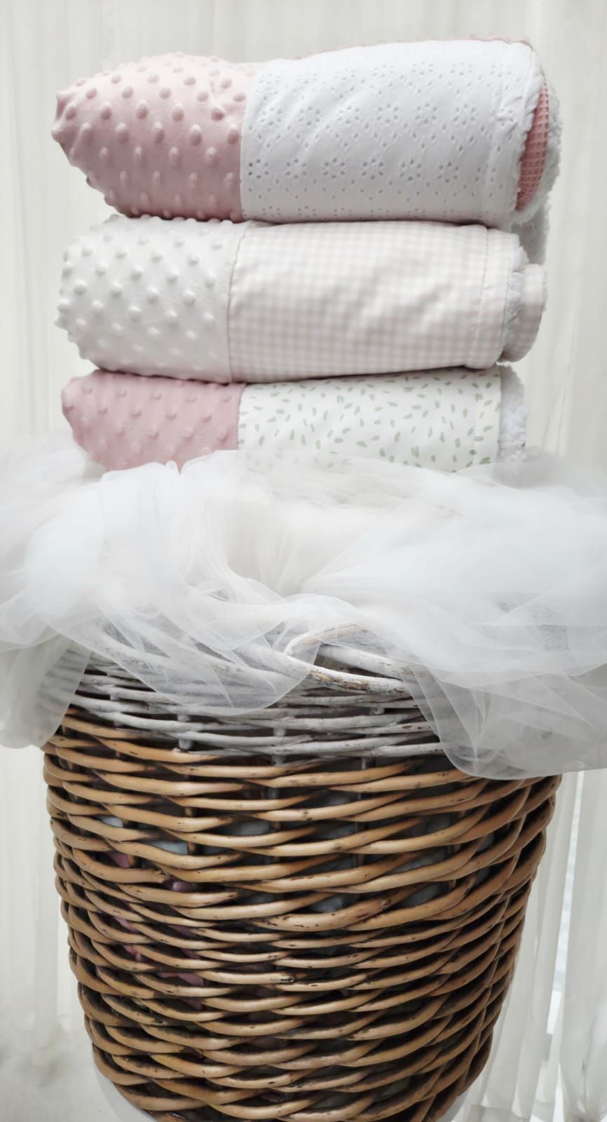Pink and white patchwork baby quilt with minky fabric, paired with white Mary Jane shoes and floral print cloth.