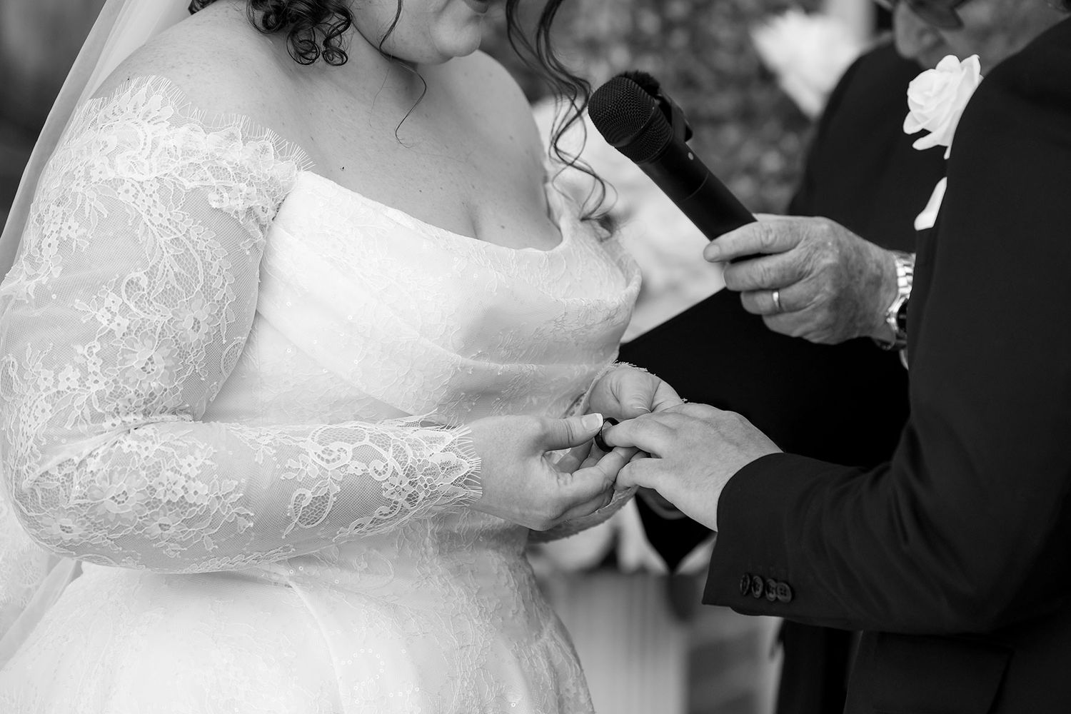 A tender moment captured in Black + White between newlyweds exchanging rings during a wedding ceremony at the Corowa Distilling Co.