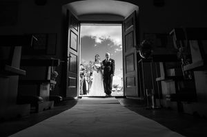 Silhouette shots inside a church showing dramatic lighting through doorways.