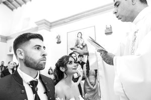 Black and white wedding ceremony photos showing intimate moments.