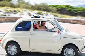 Classic white vintage car decorated for wedding transportation.