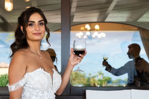 Wedding guests enjoying drinks and conversation at an elegant outdoor reception.