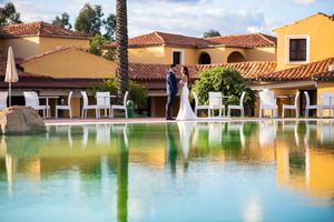 Resort venue with Mediterranean-style buildings and a serene swimming pool.
