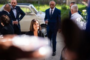 Wedding party members in formal attire gathered outside.