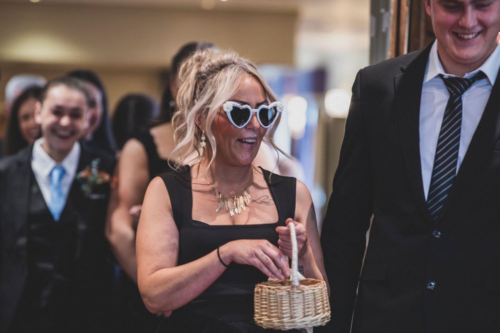 Wedding guests enjoying a sunny outdoor celebration with heart-shaped sunglasses.
