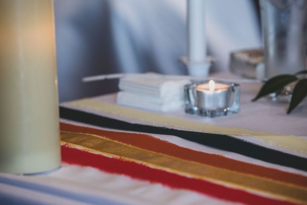 White tablecloth and place settings at formal event with soft lighting.