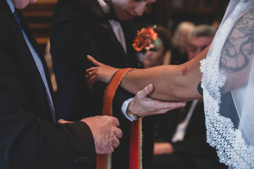 Guests dancing and celebrating at an indoor wedding reception.