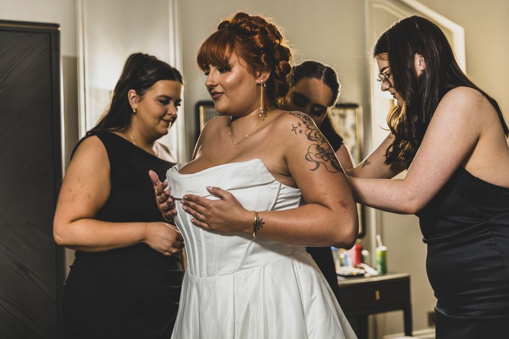 A series of candid moments showing people in black and white outfits embracing and dancing together at a celebration.