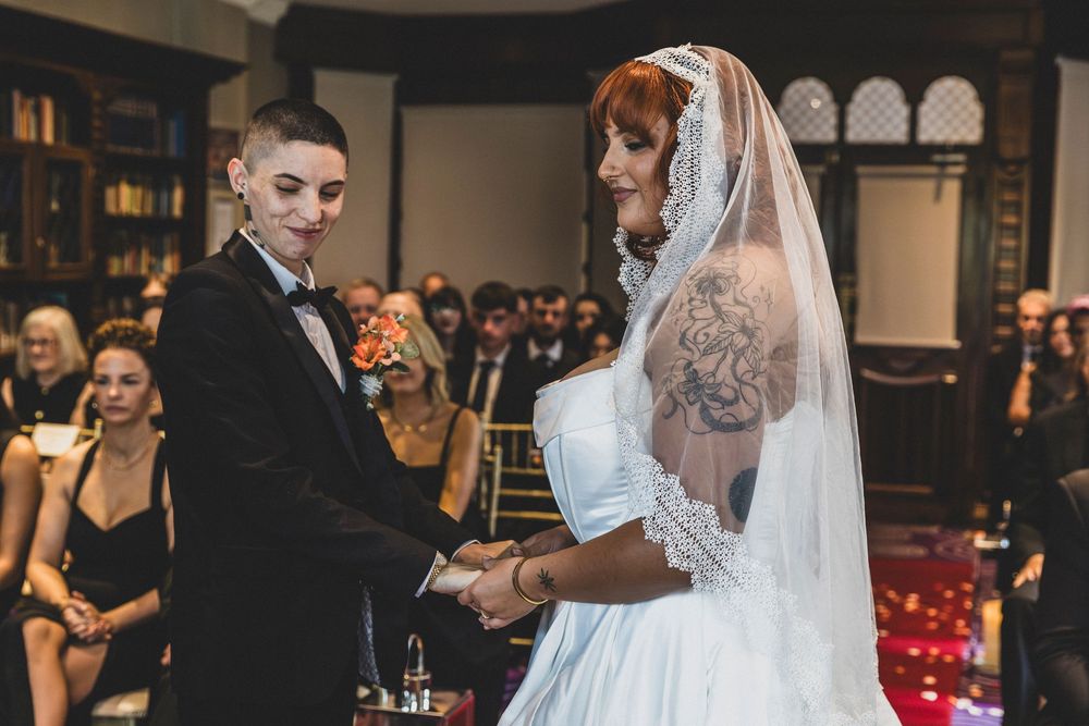 Indoor wedding ceremony with elegant decor and soft lighting.