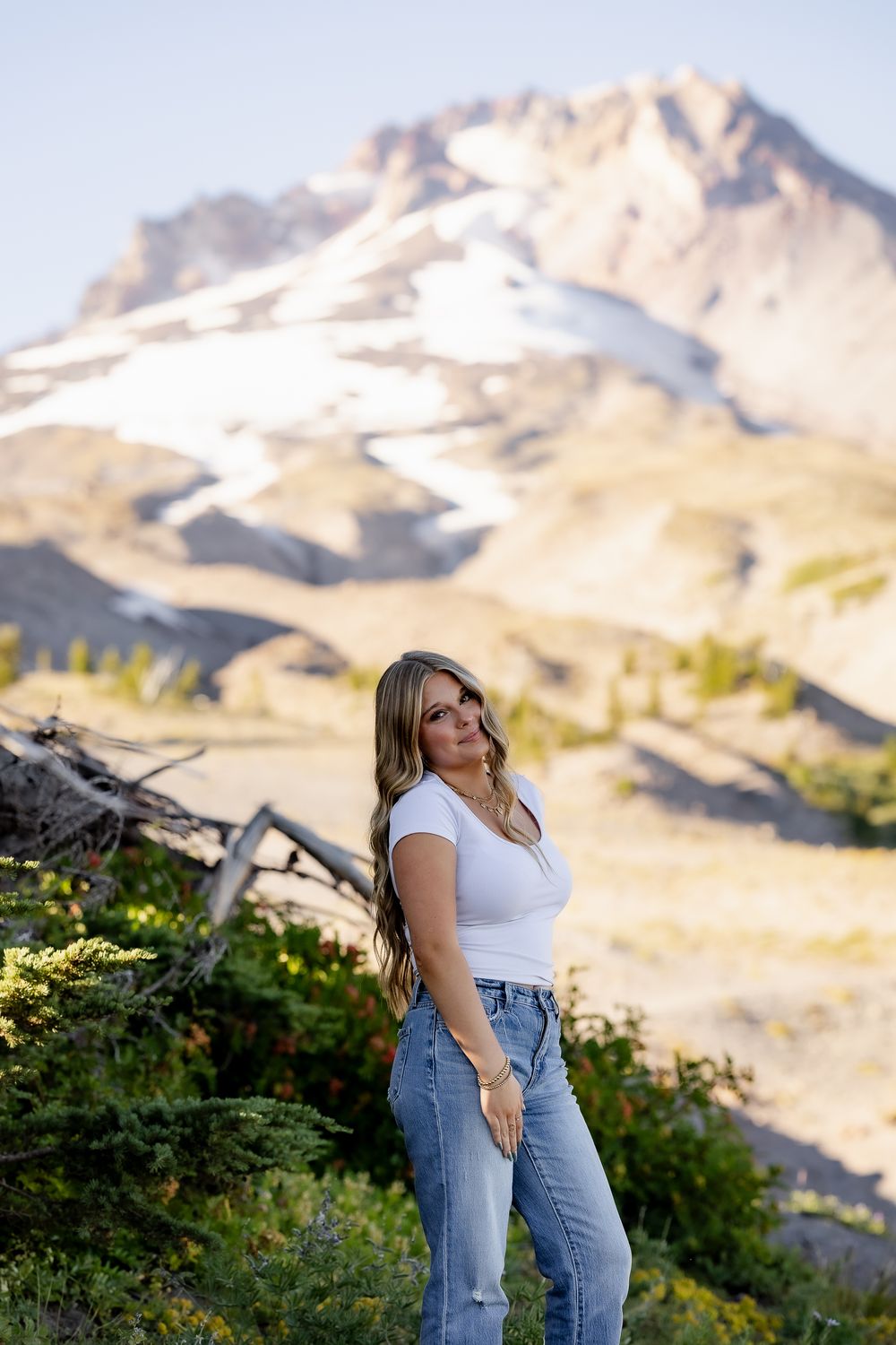 Scenic mountain landscape portrait session with snow-capped peaks in background.