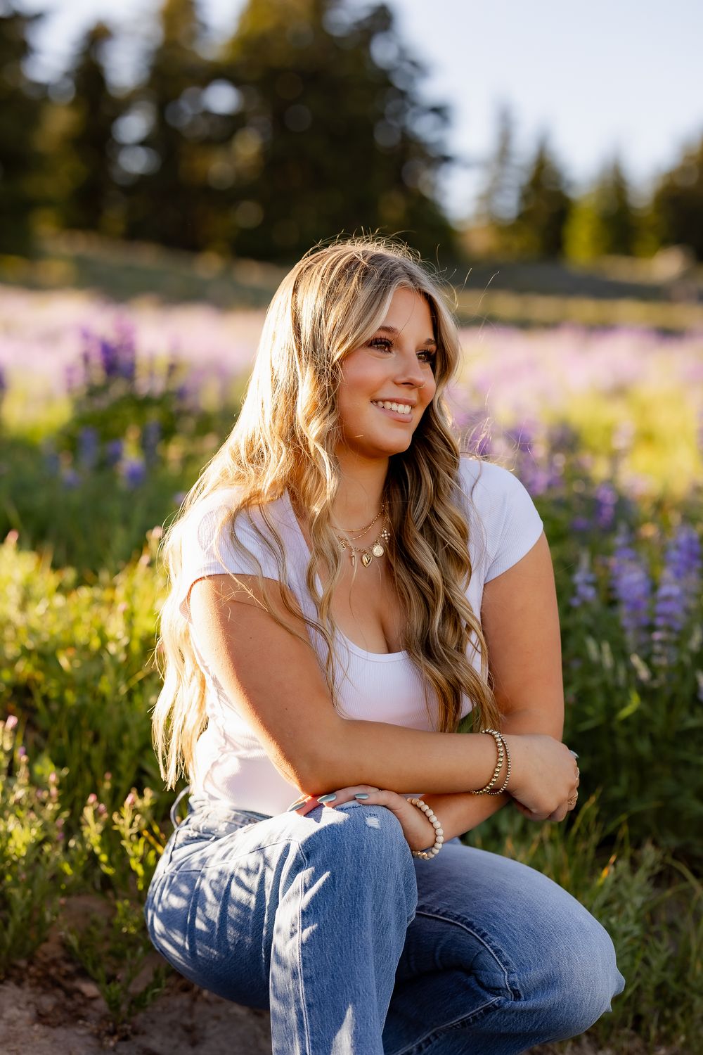 Natural light portrait session in mountain wildflower field at sunset.