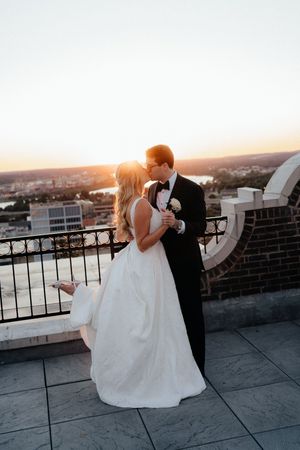 A romantic sunset rooftop photo sequence showing a couple in wedding attire embracing against a city backdrop.