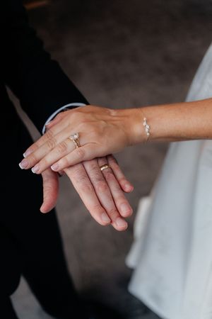 Close-up shots of hands with engagement and wedding rings showing different angles and details of the jewelry.