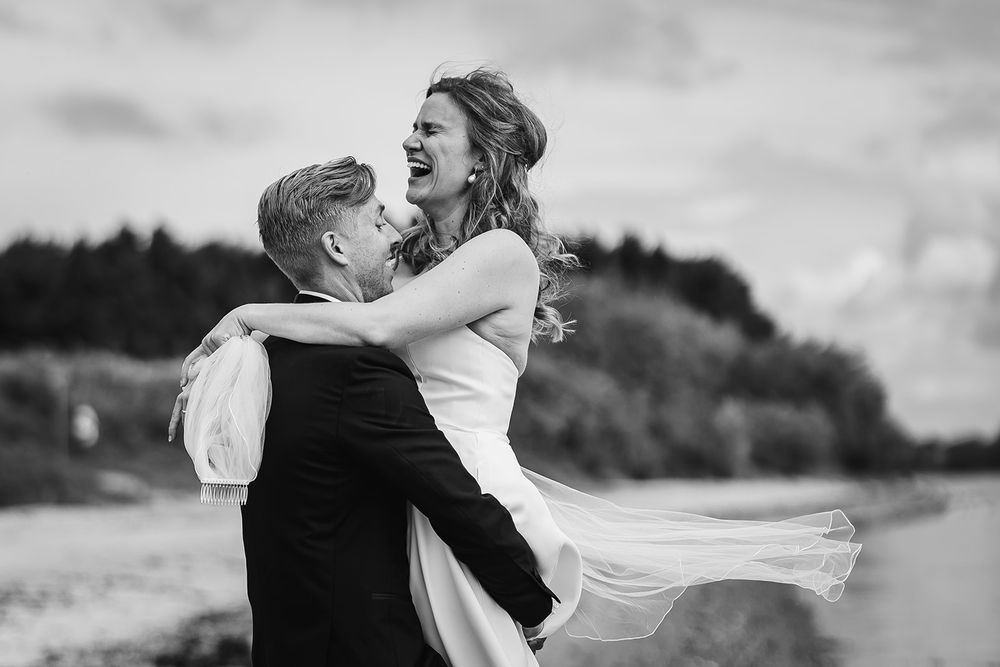 A romantic black and white wedding photo collage showing tender moments between a couple on their special day.