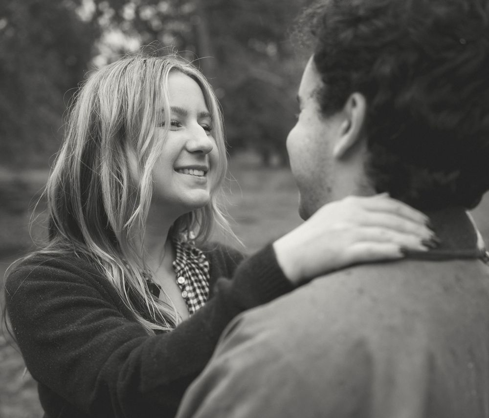 Black and white photo sequence showing a couple sharing intimate moments while embracing outdoors.