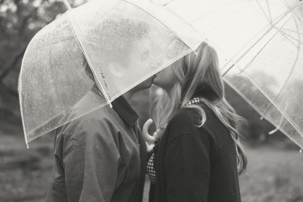 A series of black and white photos showing people holding umbrellas in the rain creating a dreamy artistic sequence.
