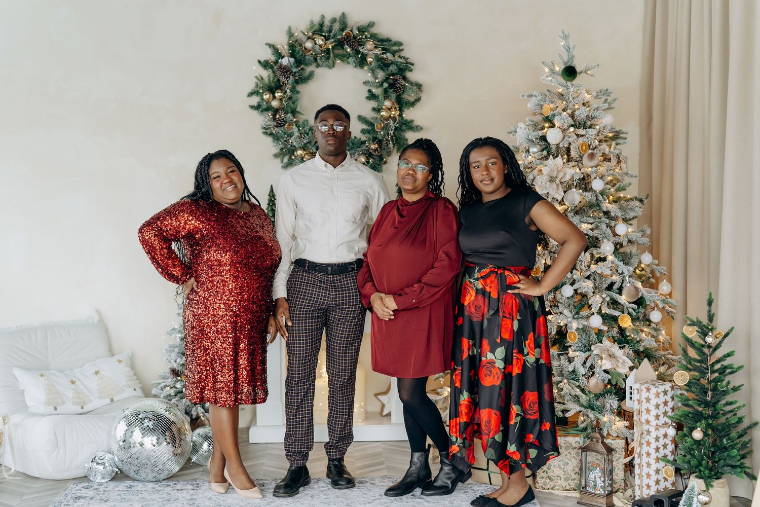 A collage of holiday family photos with people posing in front of decorated Christmas trees and festive wreaths. Christmas minis 2025