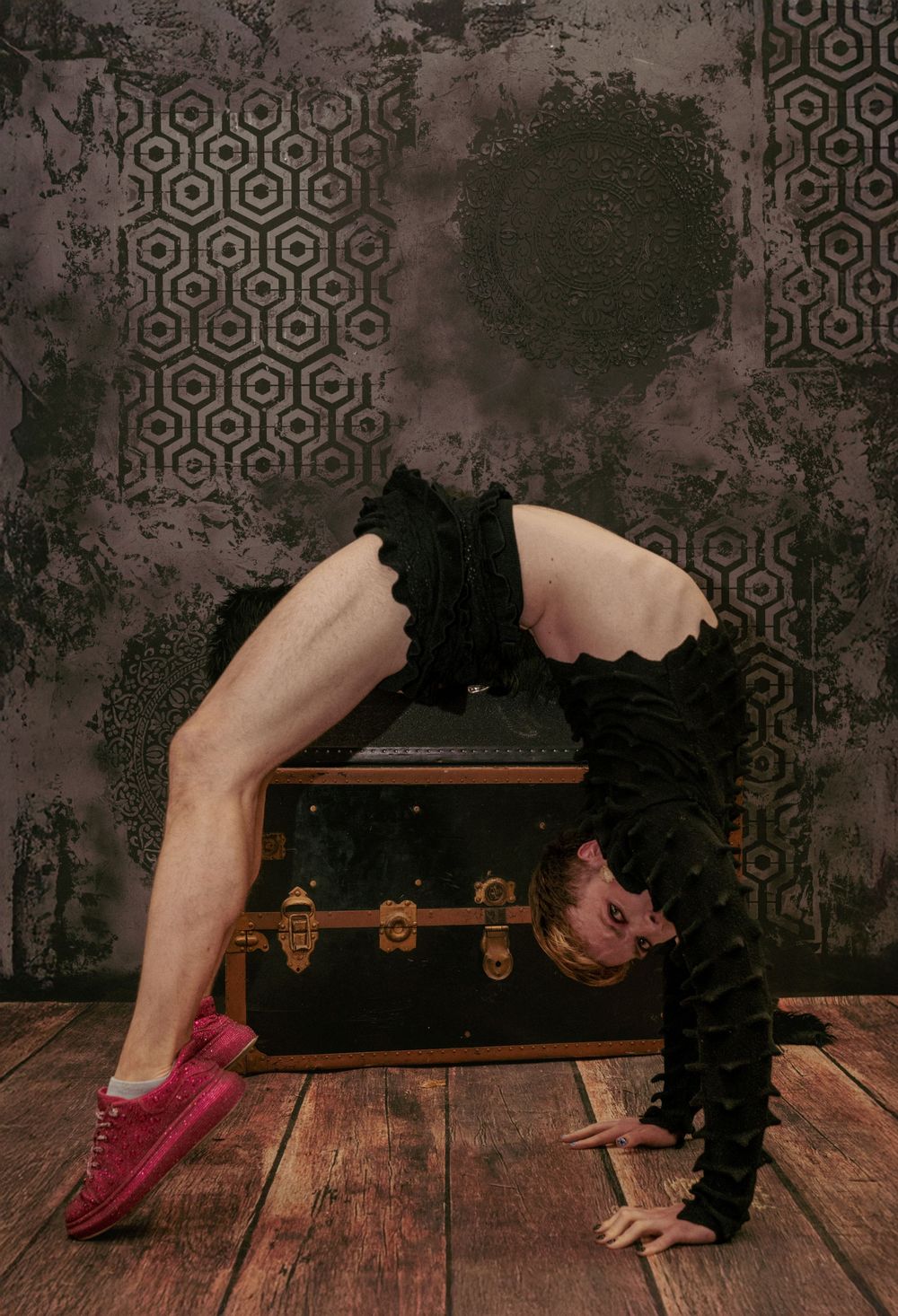 Contortionist pose at Forgotten Works Studio Portland in front of vintage trunk and textured backdrop