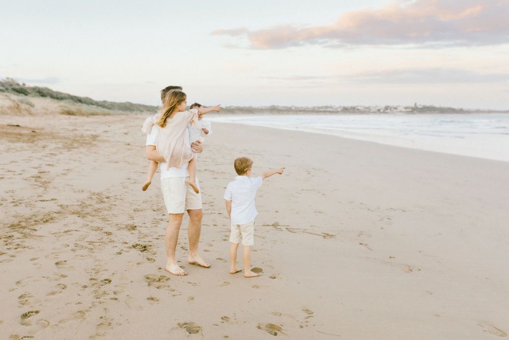 A series of beach photos showing people in white outfits walking along the sandy shore at sunset.