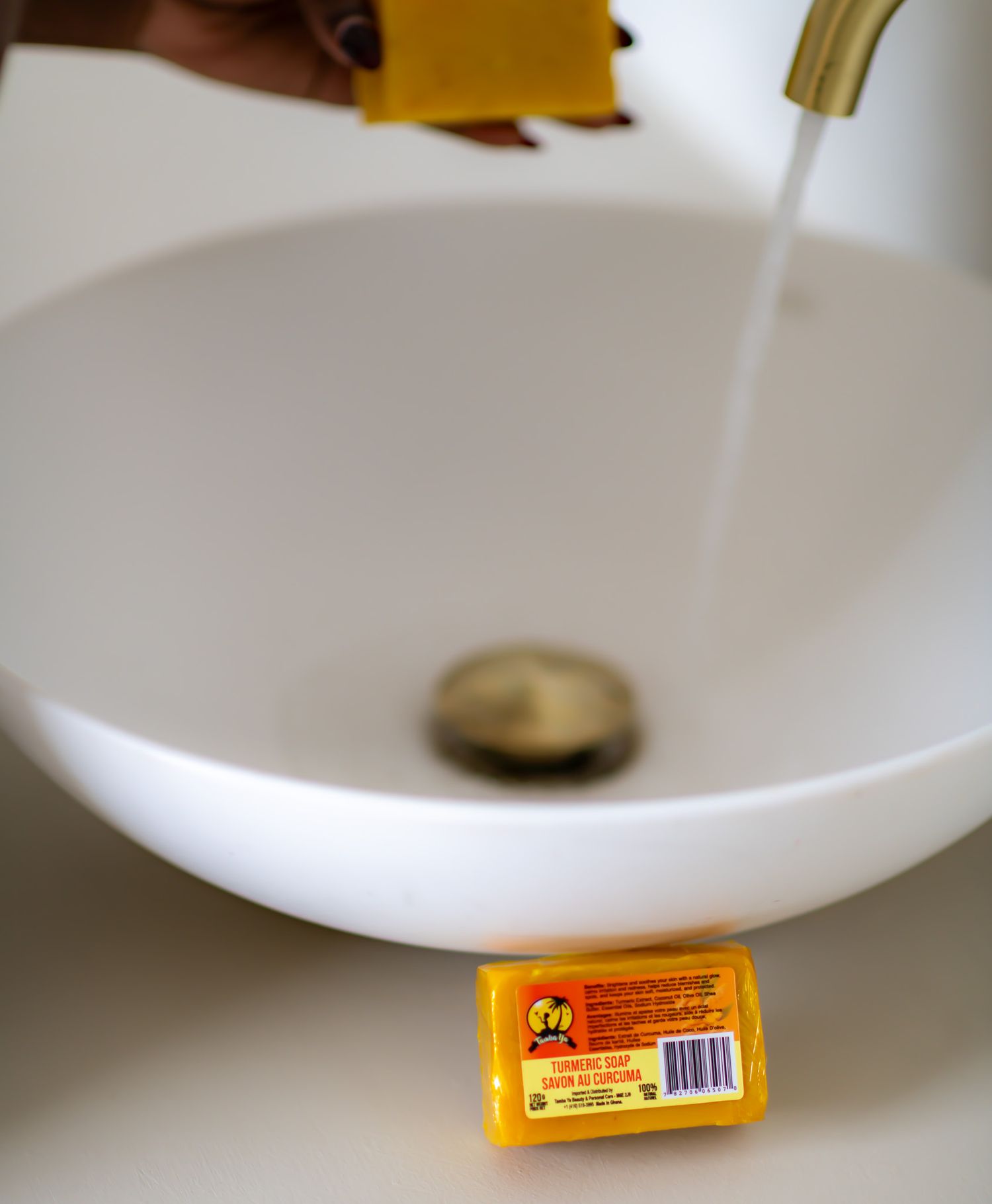 A series of white bowls and a yellow Carmex lip balm tube shown in a minimalist composition against a light background.