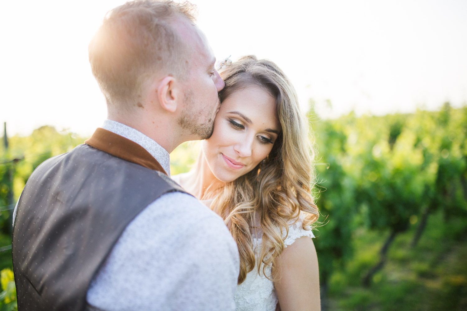 Bride and groom sharing a tender moment in a vineyard or countryside setting, Surrey wedding