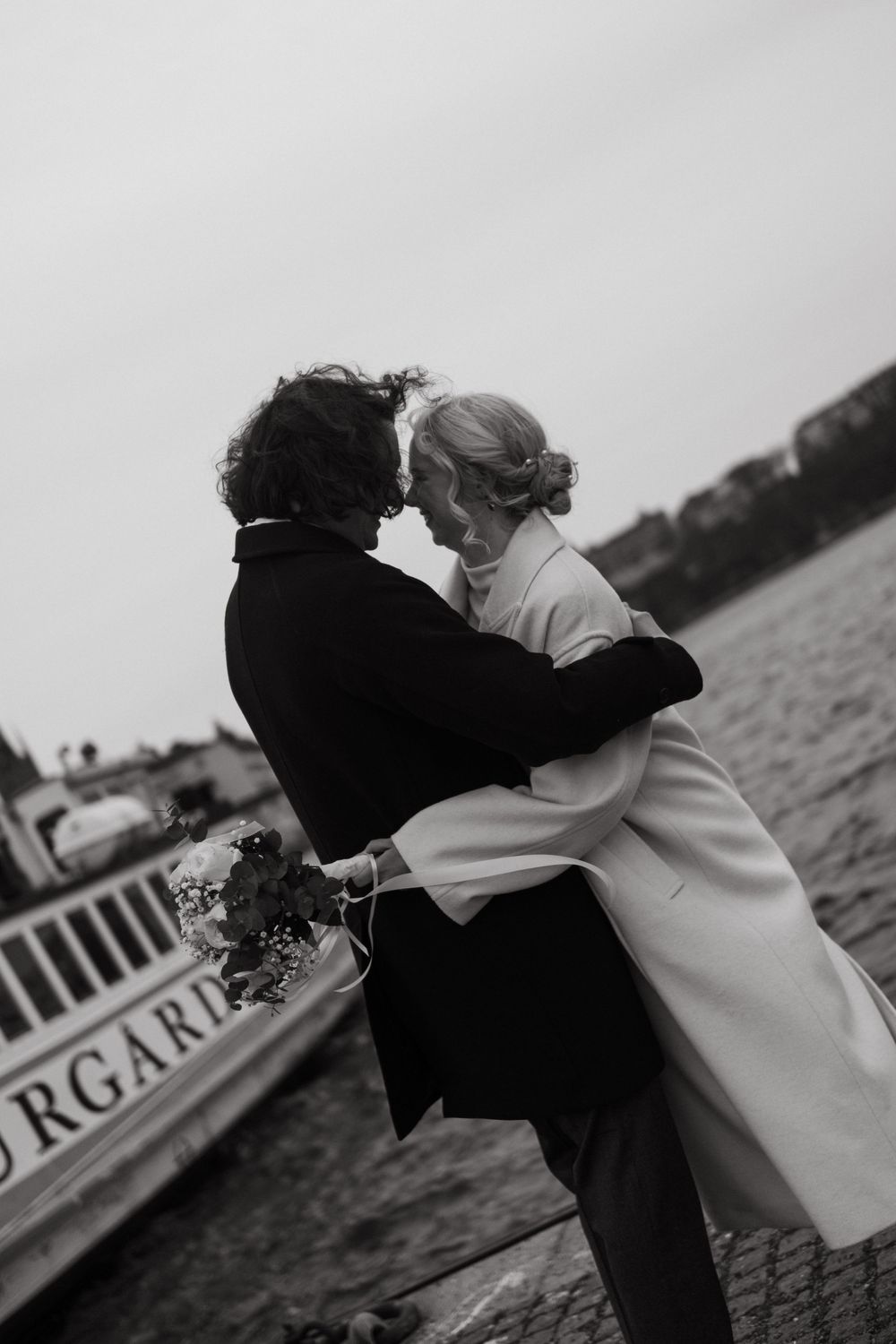 couple looking at the city view together while being captured by Stockholm City Hall wedding photographer