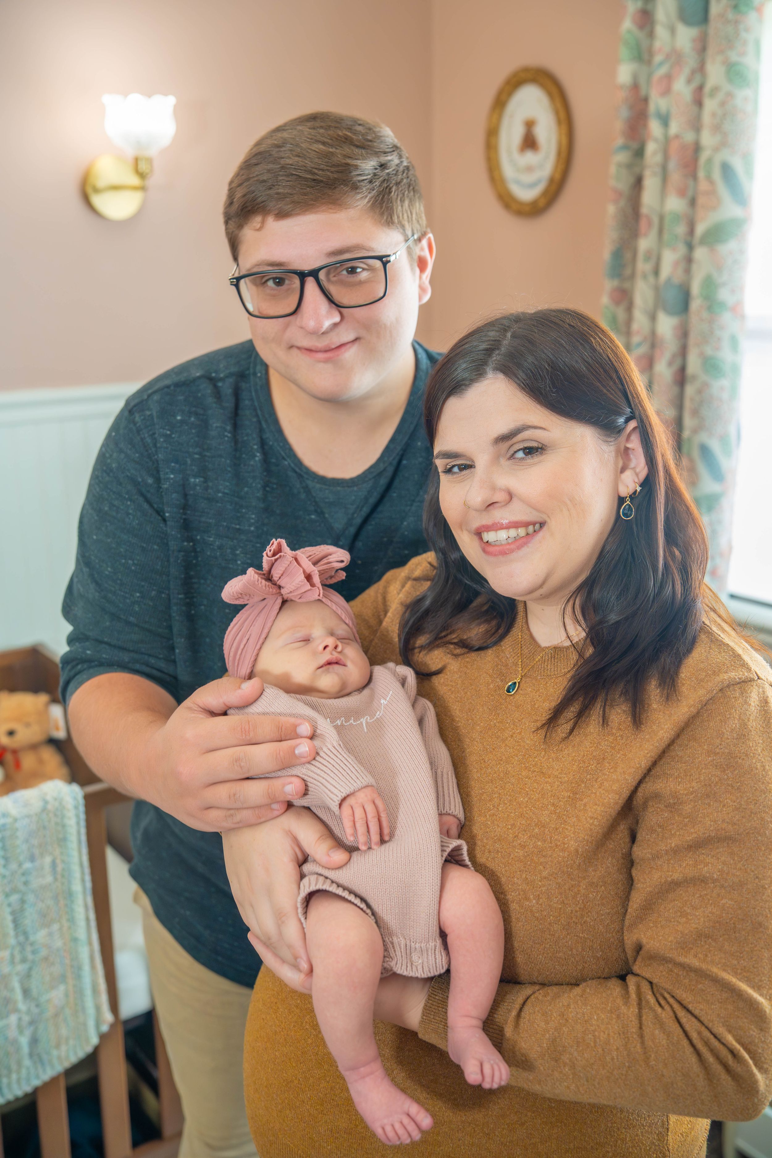 A collection of three photos showing a baby being held while wearing a pink outfit in a cozy home setting.