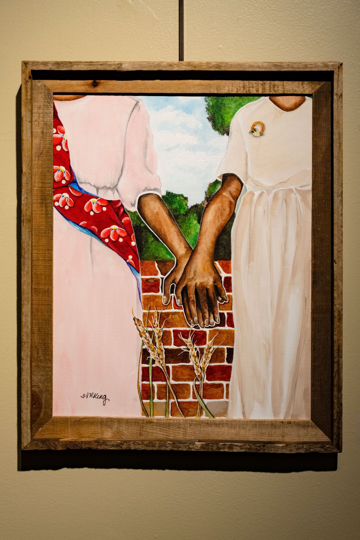 Painting showing two people in white and red clothing leaning against a brick wall.
