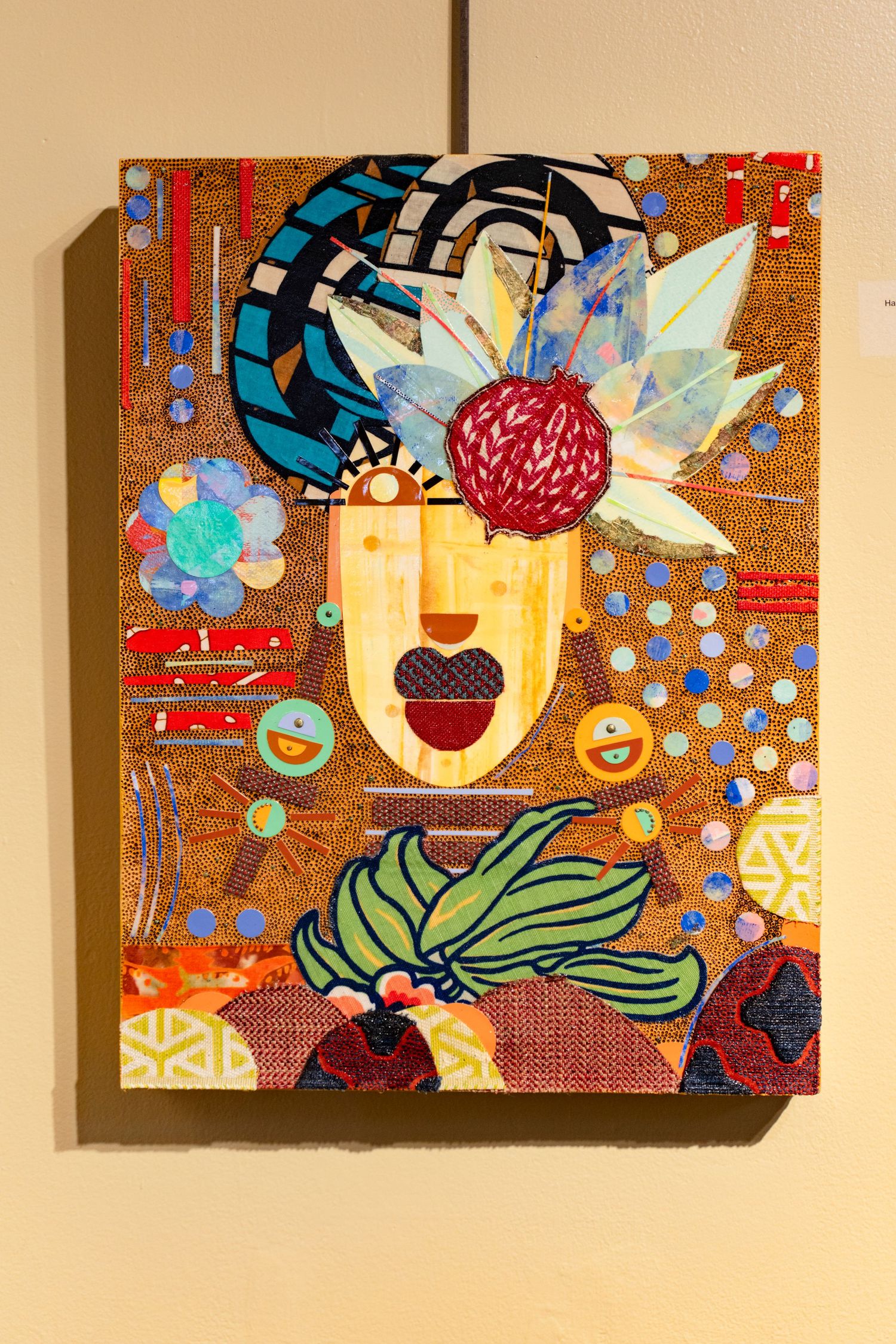 Colorful mixed media portrait featuring geometric patterns and floral elements on textured background.