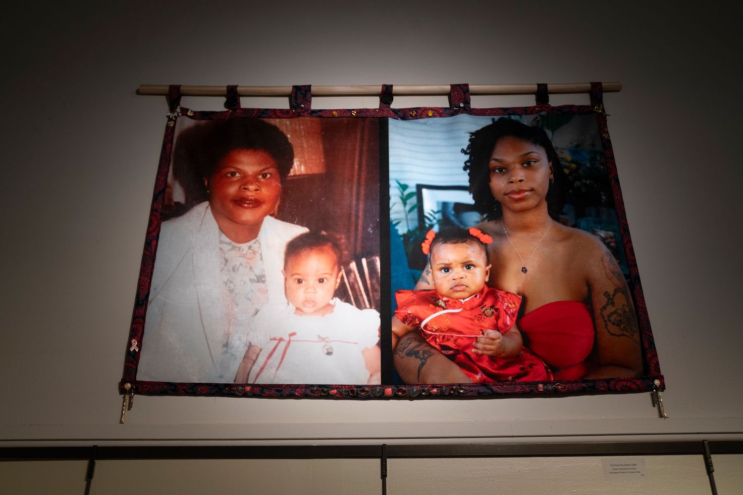 Vintage family photograph displayed in bamboo frame on gallery wall.