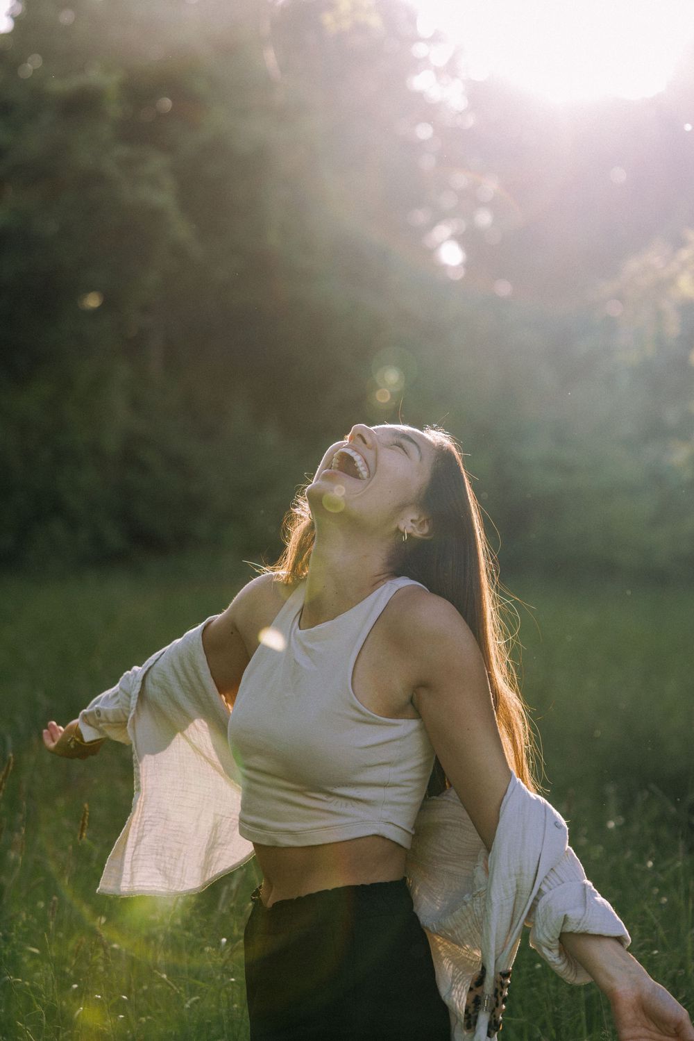 Expressive movement in a sunlit field with soft natural lighting.