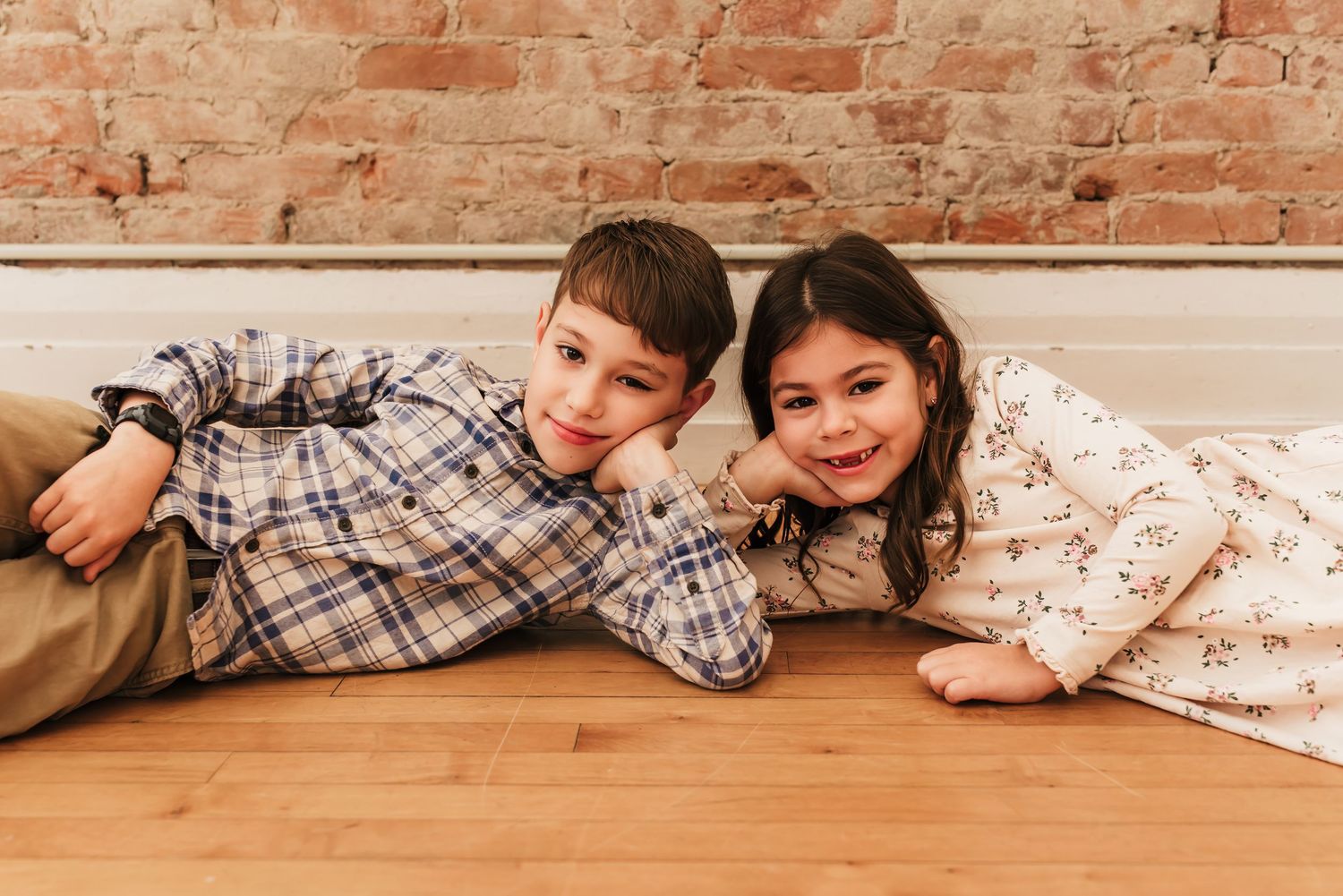 Brother and sister do a fun pose together.