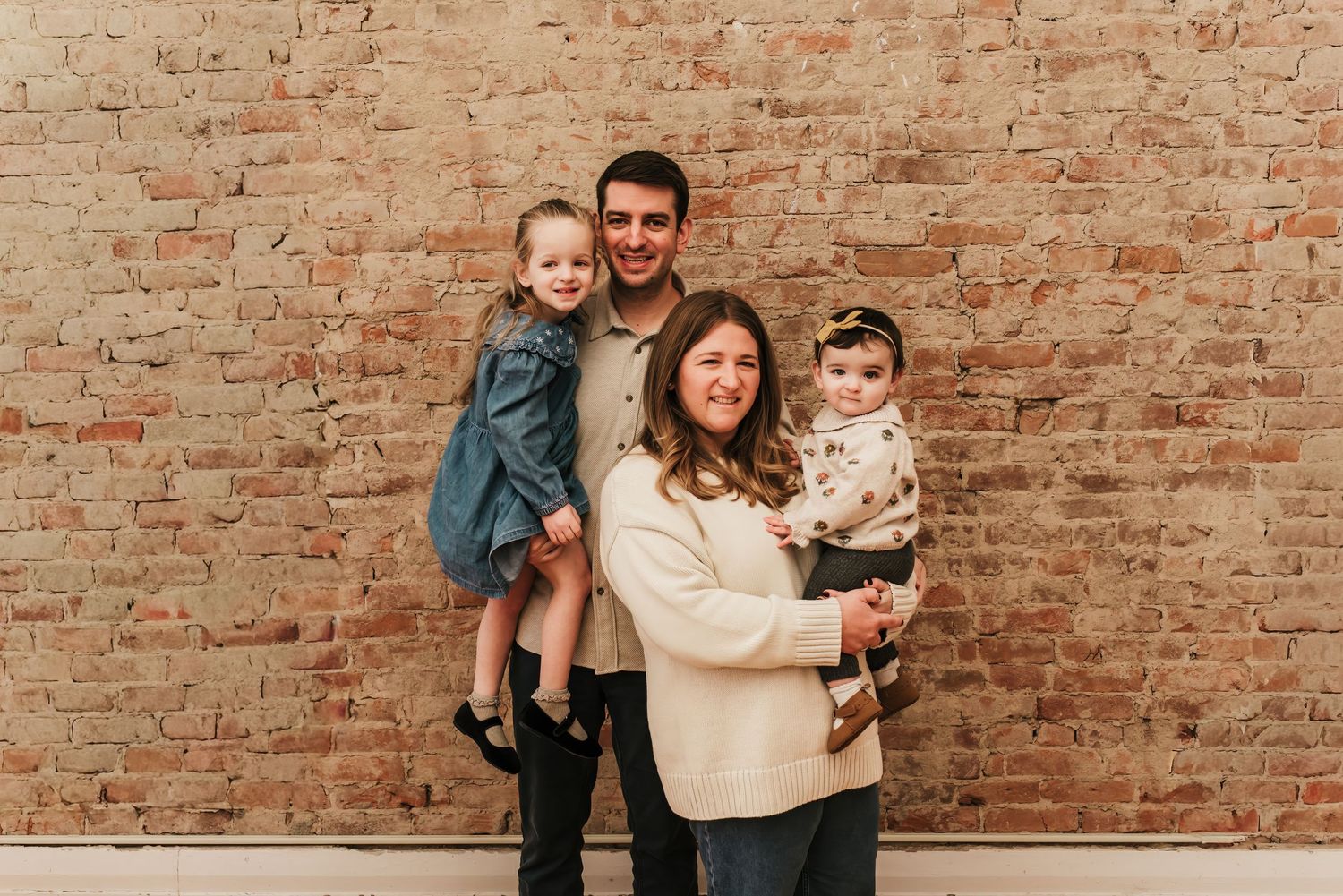 Parents hold their children and smile together for their family photos in Cincinnati