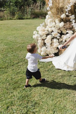 Ringbearer handing over rings to bride,