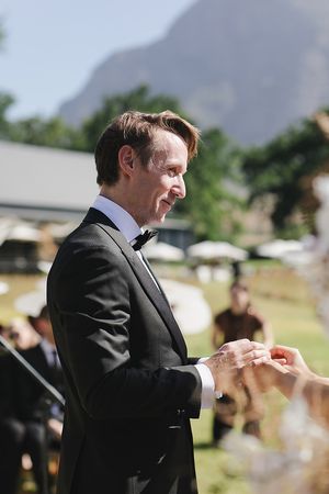 Groom during his vows giving the bride her ring.