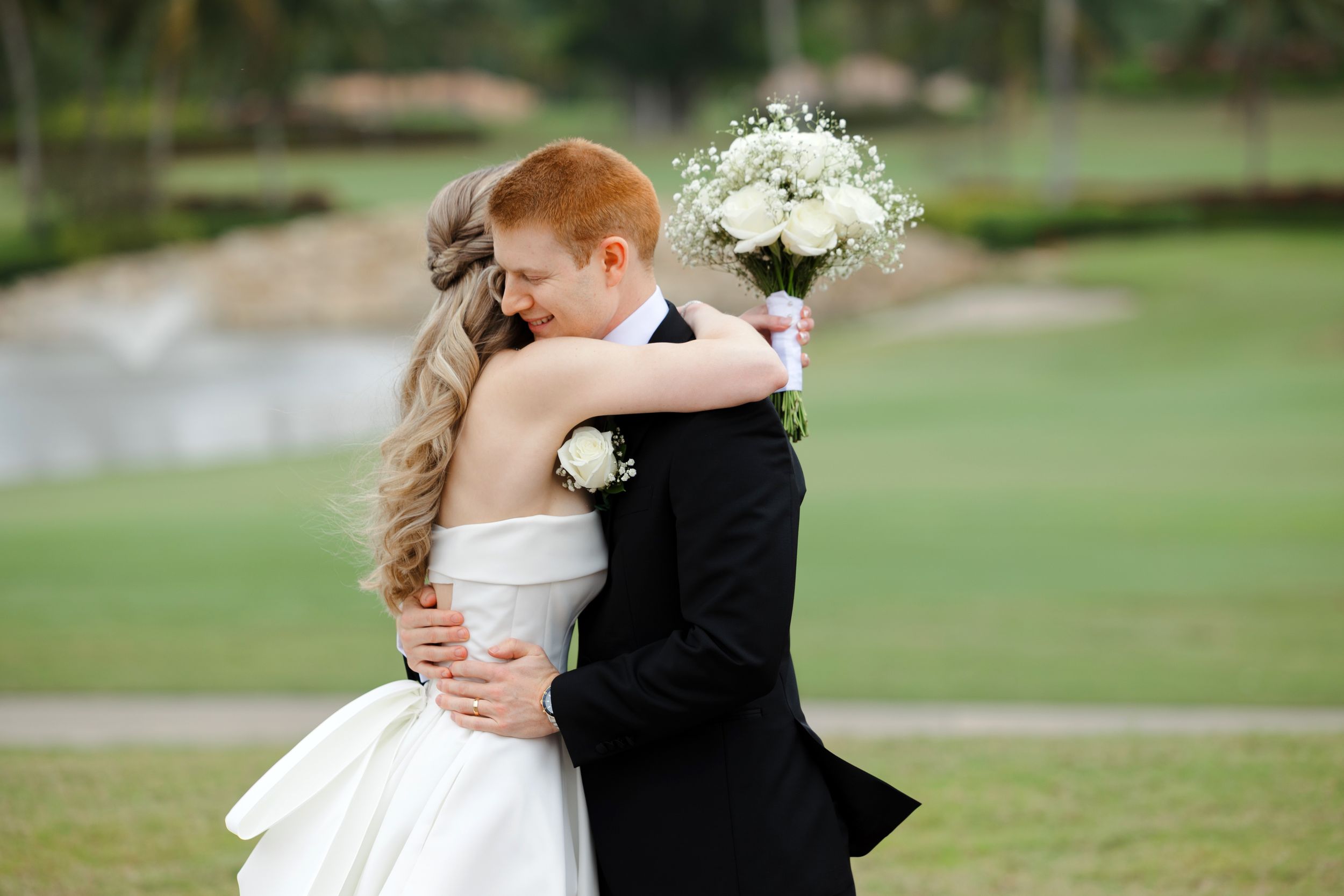 Bride and groom embrace at BallenIsles Country Club in Palm Beach, Florida during a wedding photographed by Tom Forrest of Ohio.