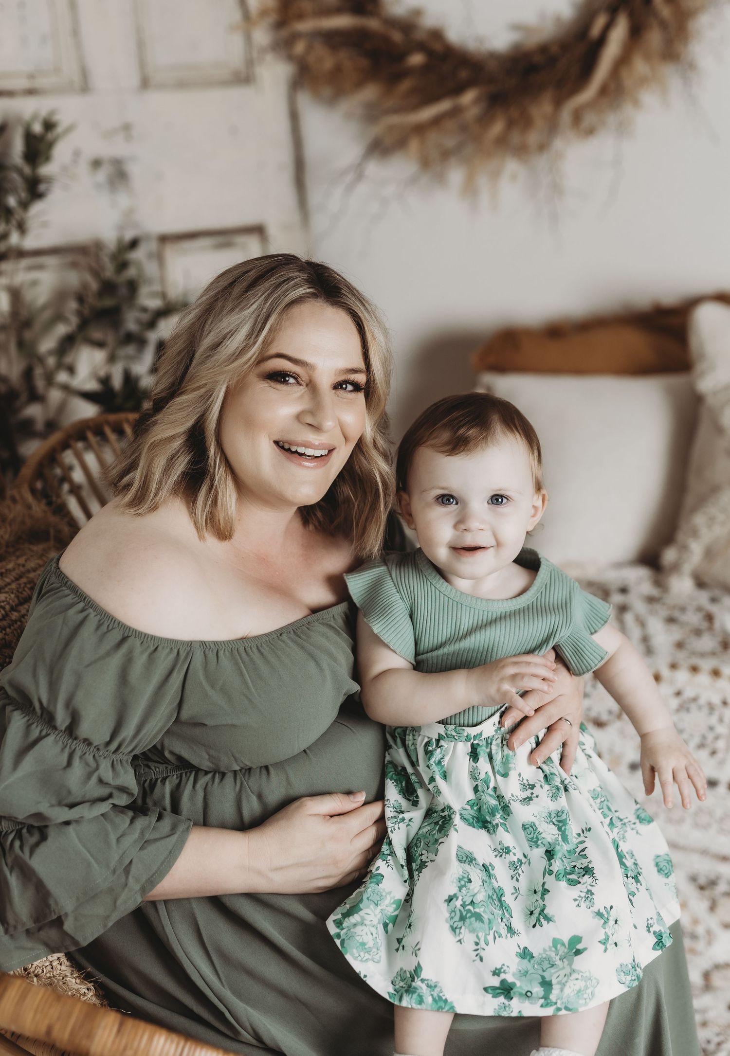 Sweet indoor portrait session featuring coordinating green outfits and natural lighting.
