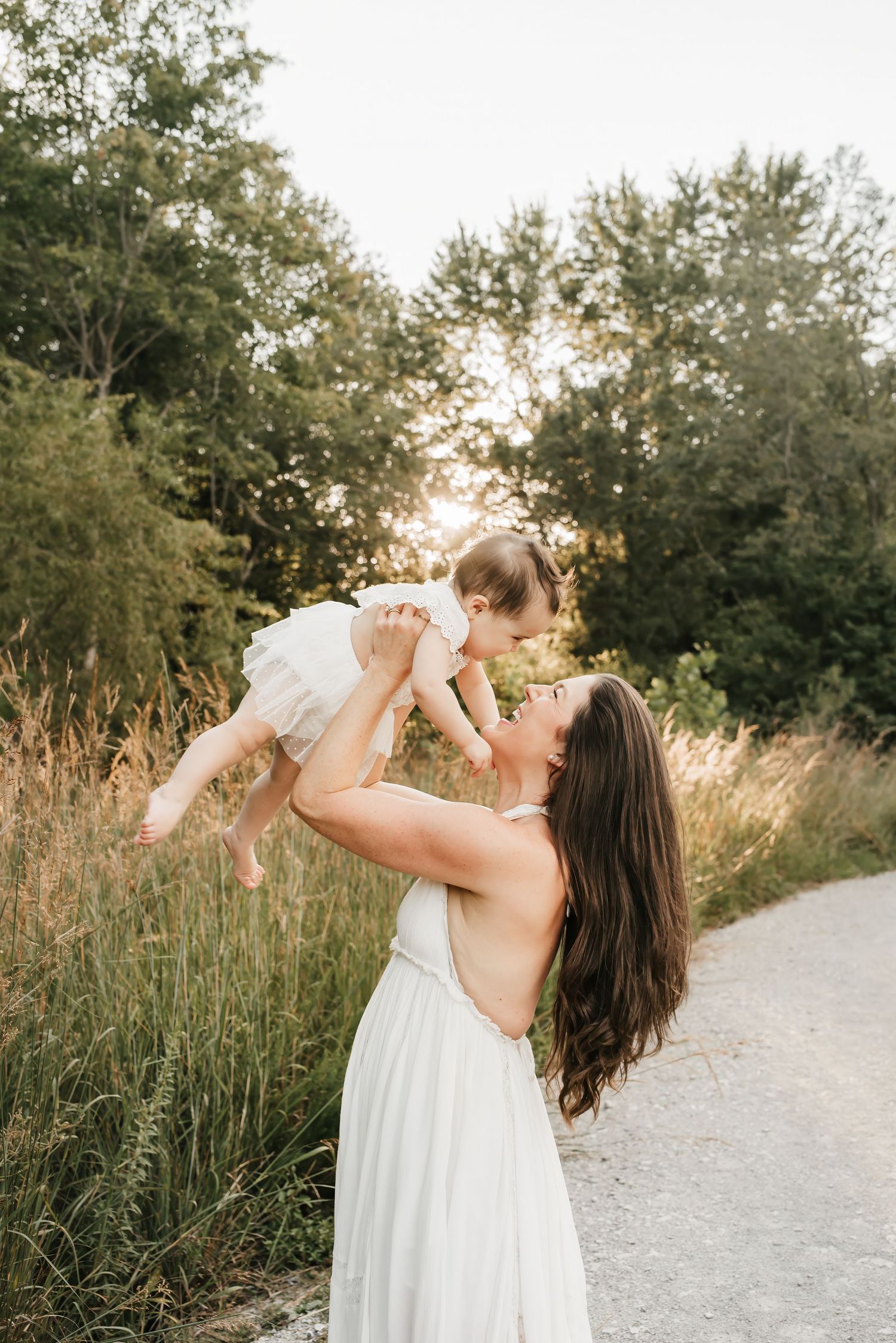 Mom spins around with daughter during golden hour family session in Cincinnati.