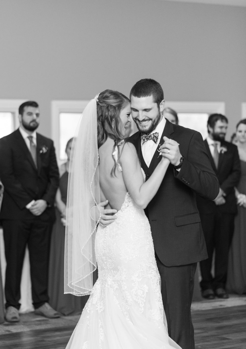 A romantic dance moment captured in black and white during a wedding reception.
