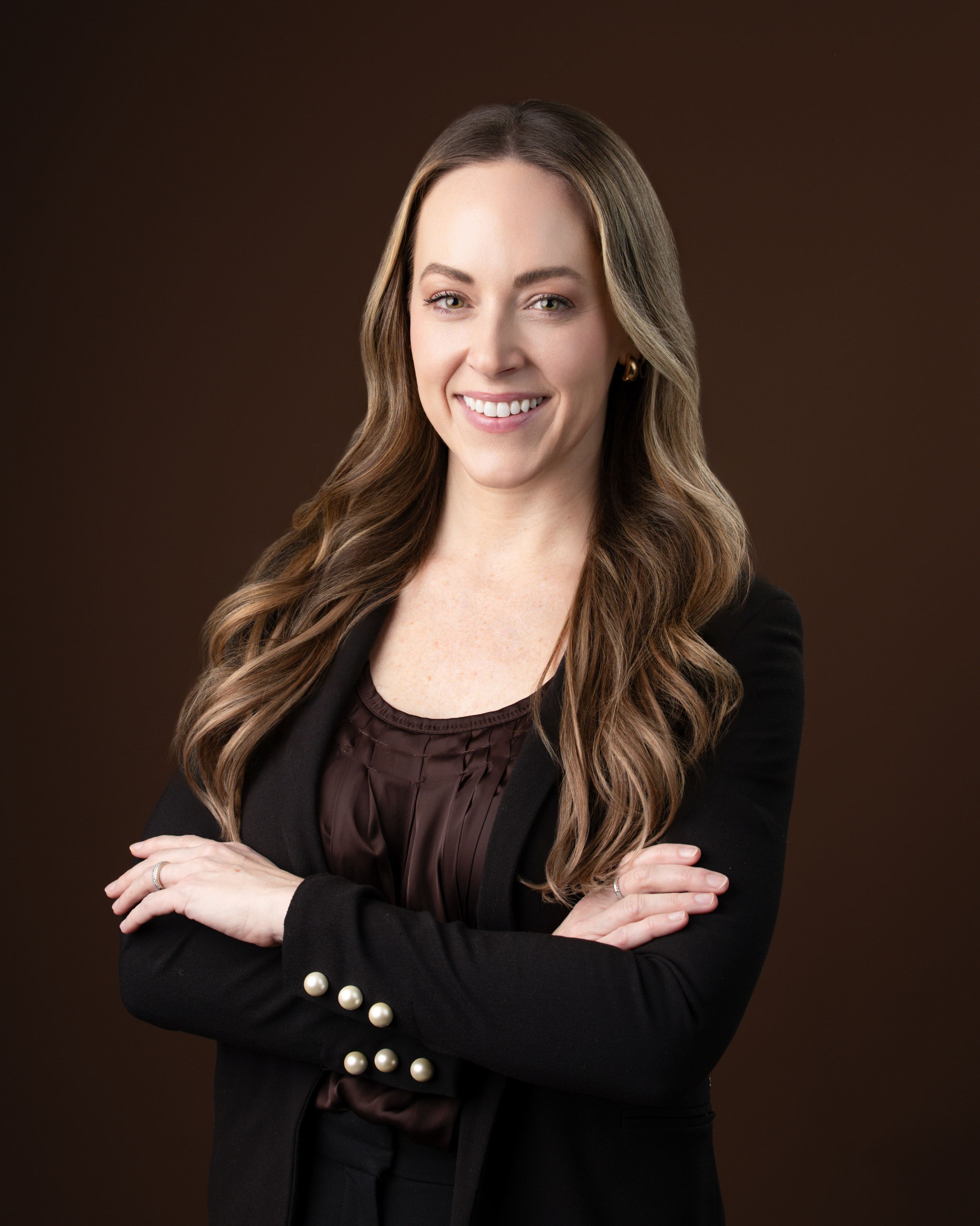 Professional studio portrait series showing a person in a black top against a dark brown background with various poses and expressions.