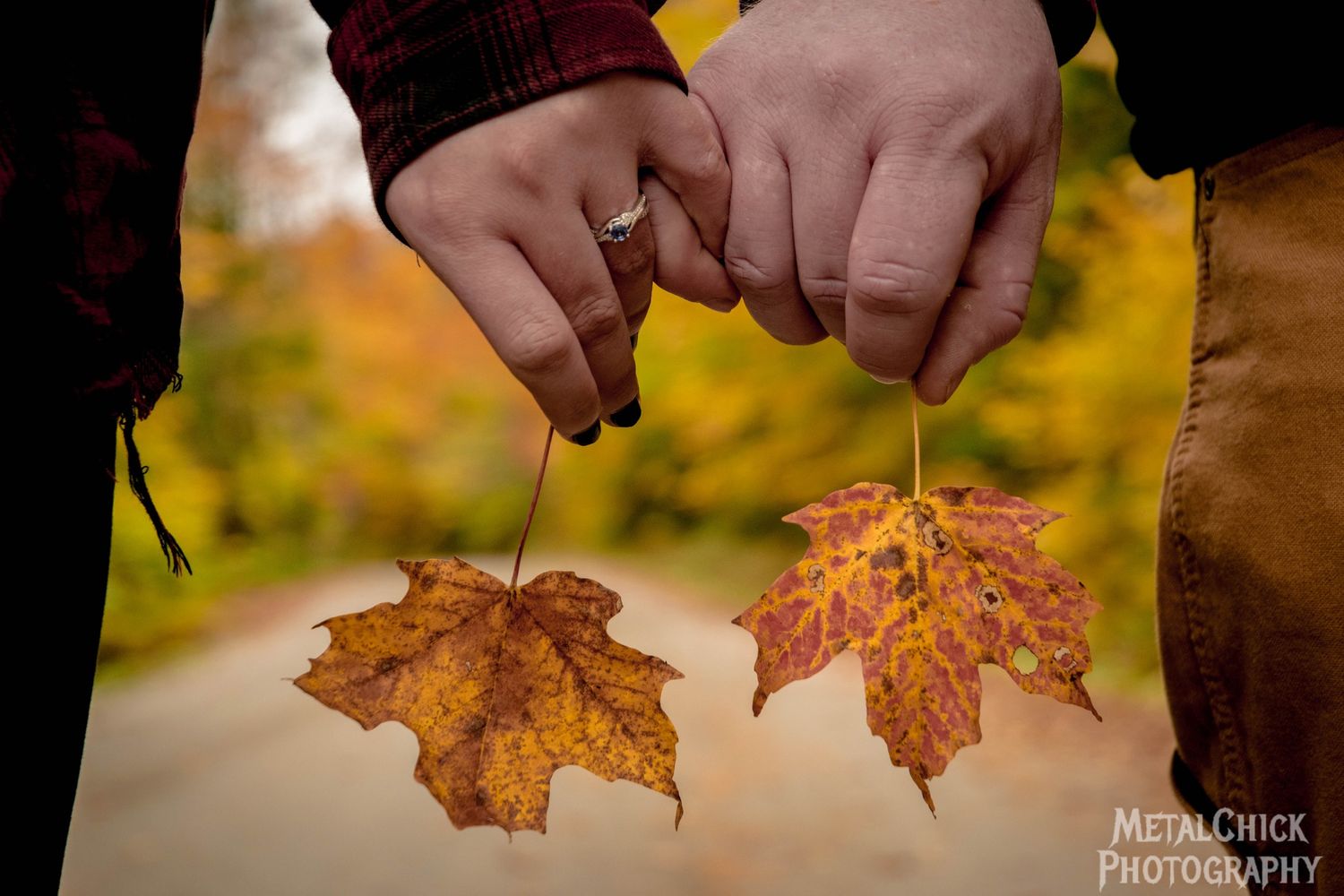 Enagement photo by Northern Exposure featuring a close-up of the engagement ring, couples hands, and maple leafs.