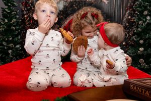 A series of holiday photos showing children in matching winter pajamas playing and interacting on a red blanket.