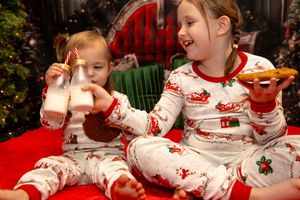 Children in red and white holiday sleepwear gather together for a festive Christmas photo shoot.
