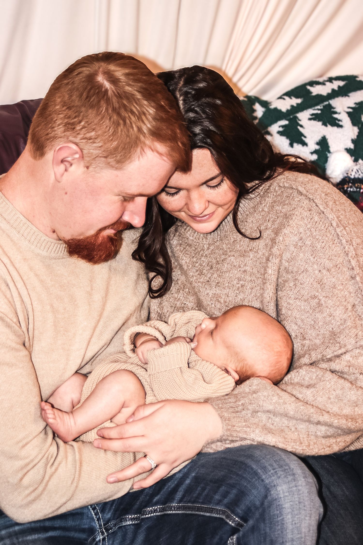 Intimate in home lifestyle, newborn photo of a parent, holding their baby and soft natural light in Michigan