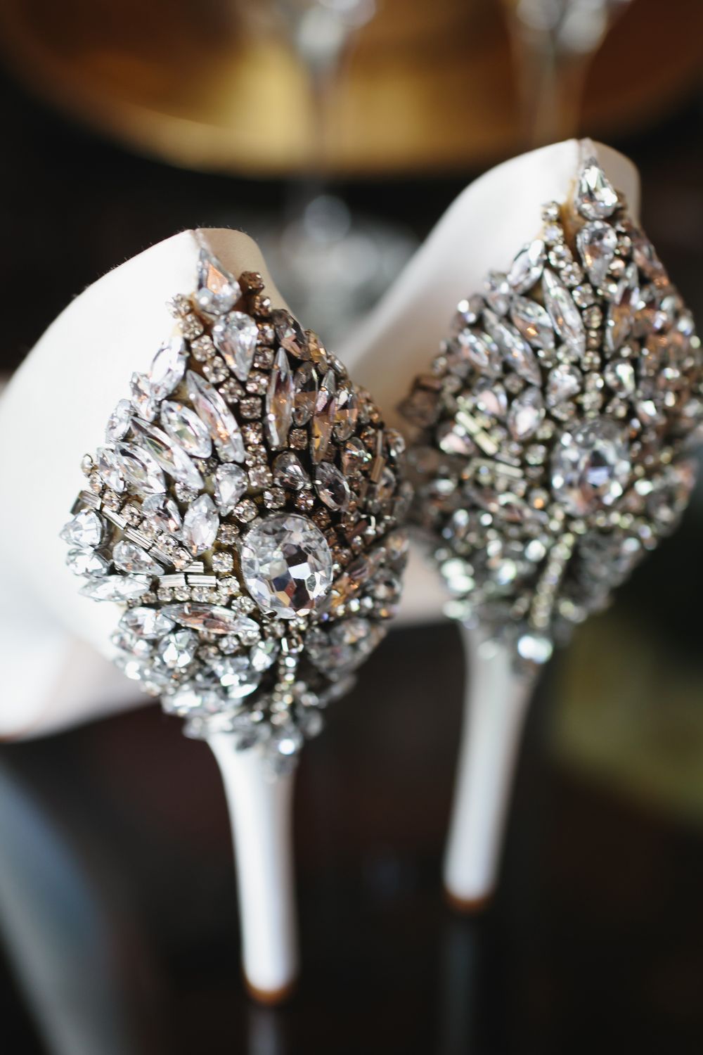 Crystal brooch bouquet handles wrapped in white ribbon sparkle with vintage rhinestone jewelry details.