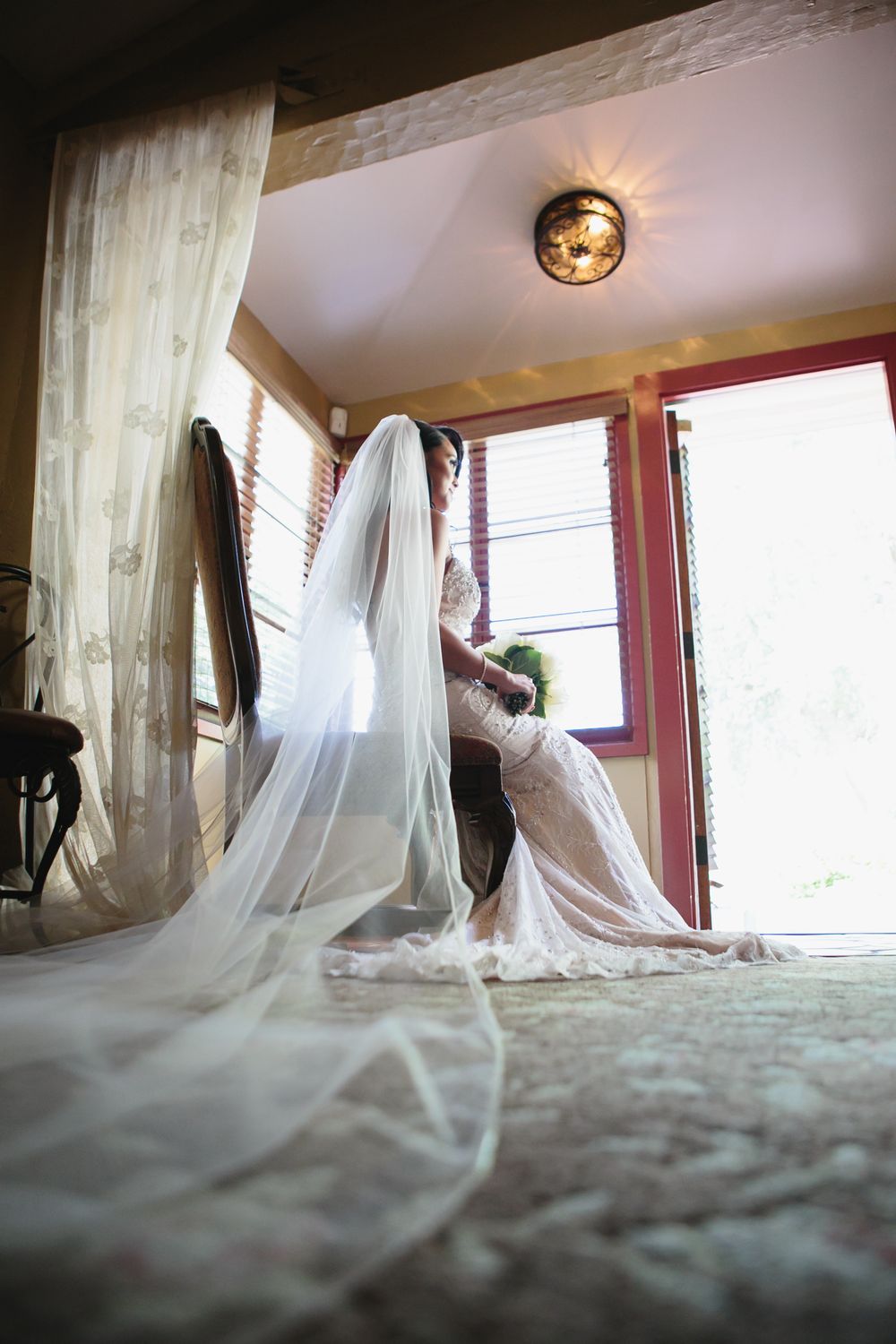 A flowing white wedding dress train sweeps across a light carpet in a series of artistic detail shots.