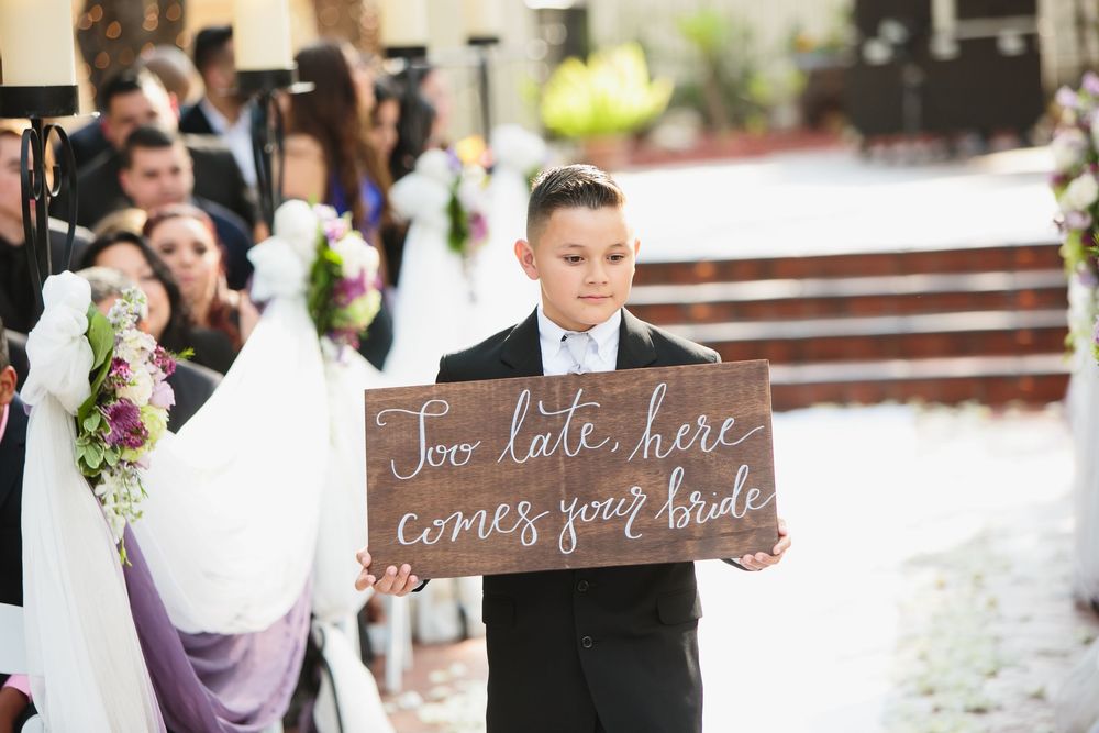 A collage of rustic wedding decorations and signs with wooden elements and floral arrangements at an outdoor ceremony.