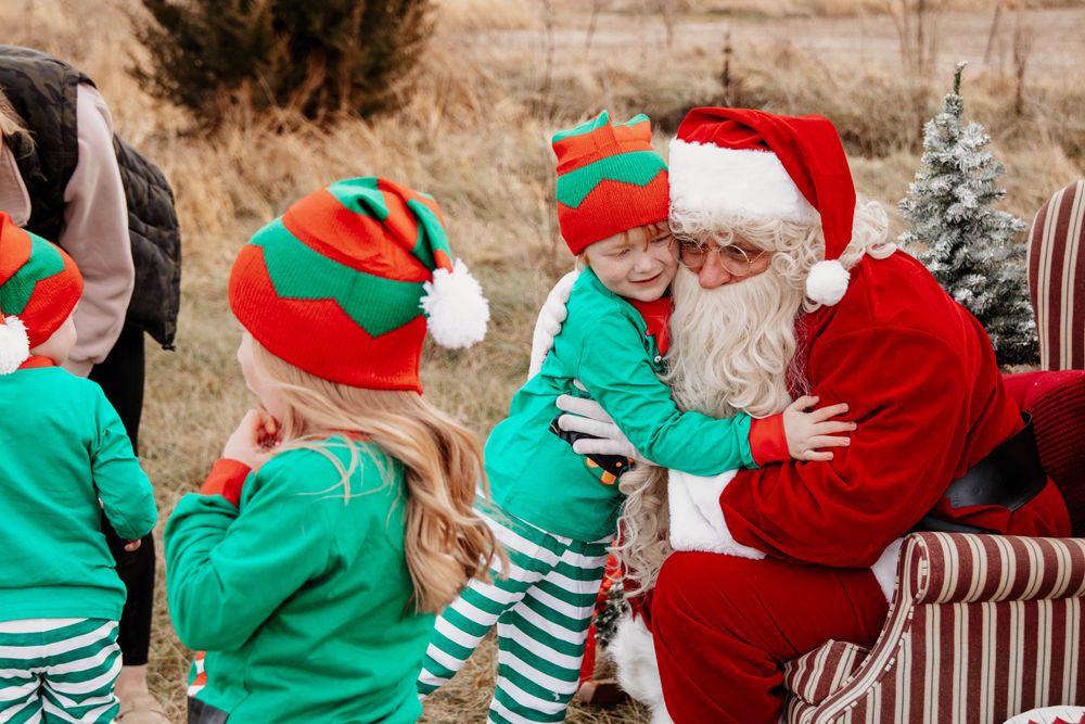 A magical holiday moment with green striped outfits and red costumes against snowy trees.